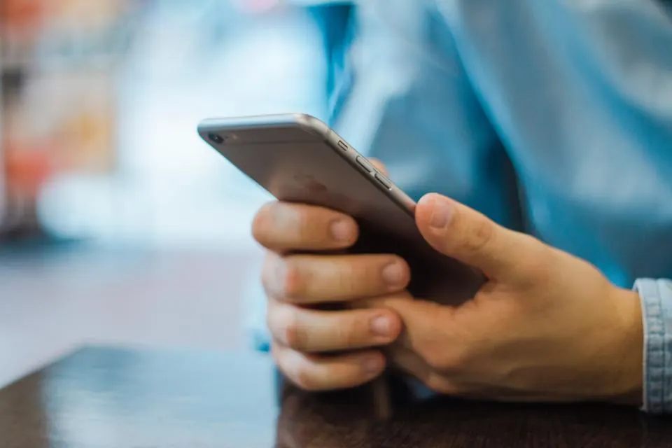 A hand holding a smartphone