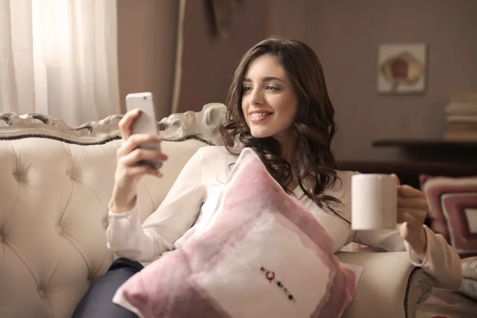 A smiling client reading on her phone